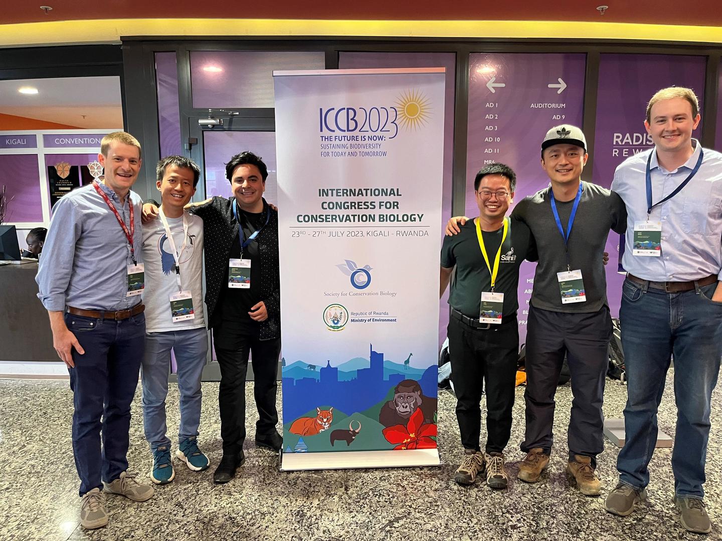 Six members of Wilcove group pose by ICCB conference sign